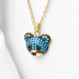 DIJE DE ACERO DORADO CARITA DE OSO C/STRASS CELESTE
