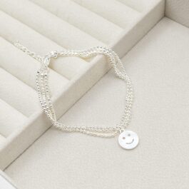 PULSERA ACERO BLANCO TRIPLE MICROBOLITA C/1 DIJE DE CARITA FELIZ